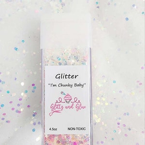 May include: A clear plastic jar filled with iridescent chunky glitter. The label reads "Glitter "I'm Chunky Baby"" Glitz and Glue 4.5oz NON-TOXIC"