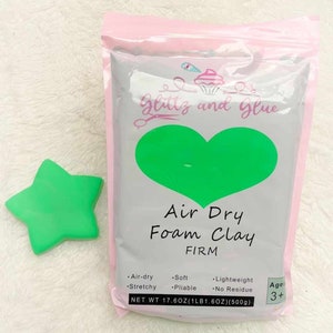 May include: A bag of green air dry foam clay labeled "Glittz and Glue" with the text "Air Dry Foam Clay FIRM" and "NET WT 17.6OZ(1LB1.6OZ)(500g)". The bag also has a heart shape with a green background and the text "Age 3+".
