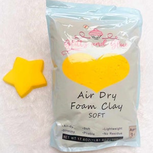 May include: A bag of yellow air dry foam clay labeled "Air Dry Foam Clay SOFT" with the text "Geitts and Glue" and a cupcake logo. The bag is 17.6 ounces (1 pound 1.6 ounces) and is for ages 3 and up.