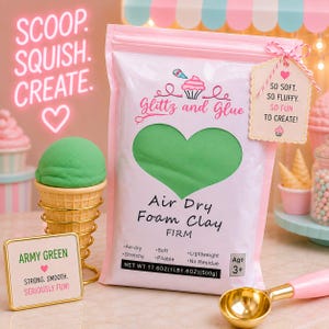 May include: A light pink pouch of Glitz and Glue Air Dry Foam Clay in army green. The packaging features a heart-shaped window, text reading "SCOOP. SQUISH. CREATE.", and a tag stating "SO SOFT. SO FLUFFY. SO FUN TO CREATE!". Net weight 17.6 oz (500g).