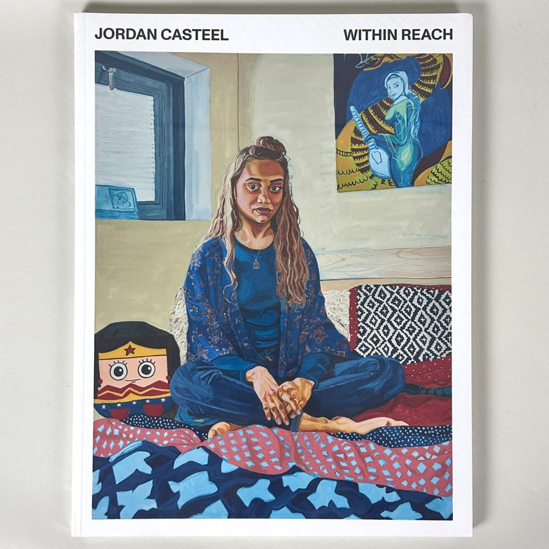 May include: A book cover featuring a painting of a woman sitting on a bed with a colourful quilt. The woman is wearing a blue shirt and a patterned robe. The book title is "Within Reach" and the author is "Jordan Casteel".