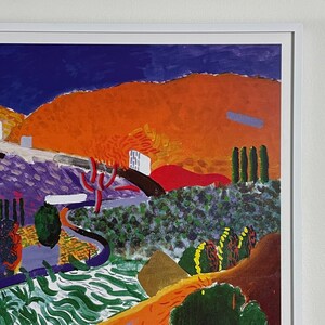May include: A colorful abstract painting with a landscape scene. The painting features a bright orange hill with a purple and green valley in the foreground. The sky is a deep blue with a few white clouds.