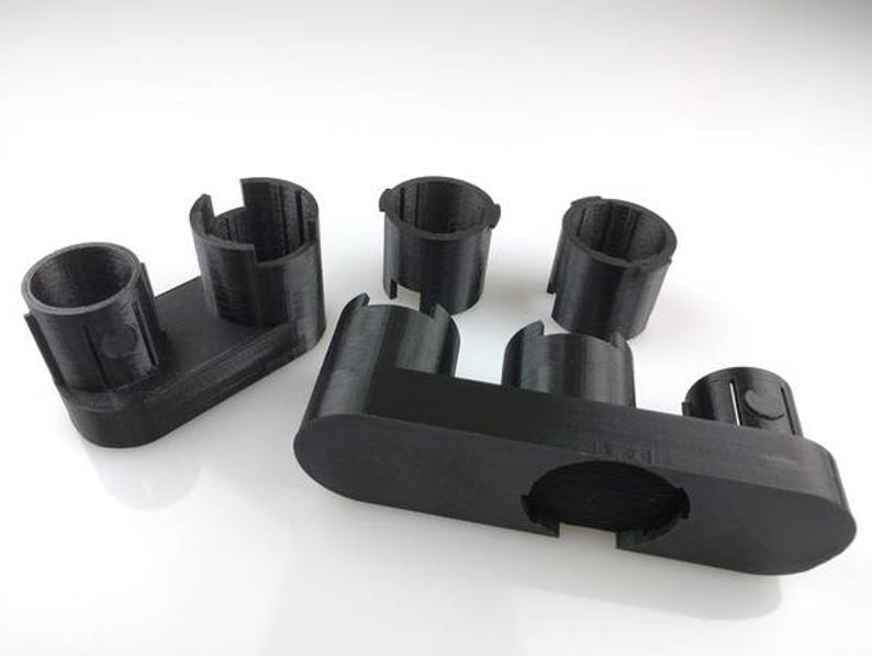 May include: A set of black plastic 3D printed organizers for small items. The organizers are designed to hold small items like pens, pencils, or other office supplies.