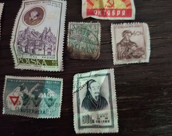 May include: A collection of vintage postage stamps featuring historical figures and landmarks. Stamps include images of Mikolaj Kopernik, a Chinese philosopher, and a stamp with the text "Australia". The stamps are in various colors and sizes.