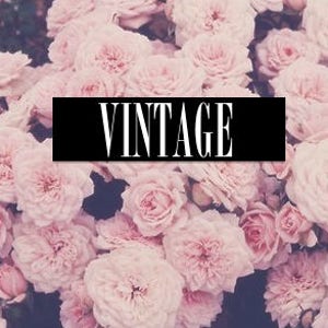 May include: A close-up image of a cluster of pink roses with the word "VINTAGE" in black text on a black background.