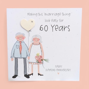 May include: A square greeting card featuring a cartoon illustration of an older couple. The text reads: Making this 'marriage thing' look easy for 60 Years. Below is the text: HAPPY DIAMOND ANNIVERSARY. The couple holds a heart-shaped balloon.