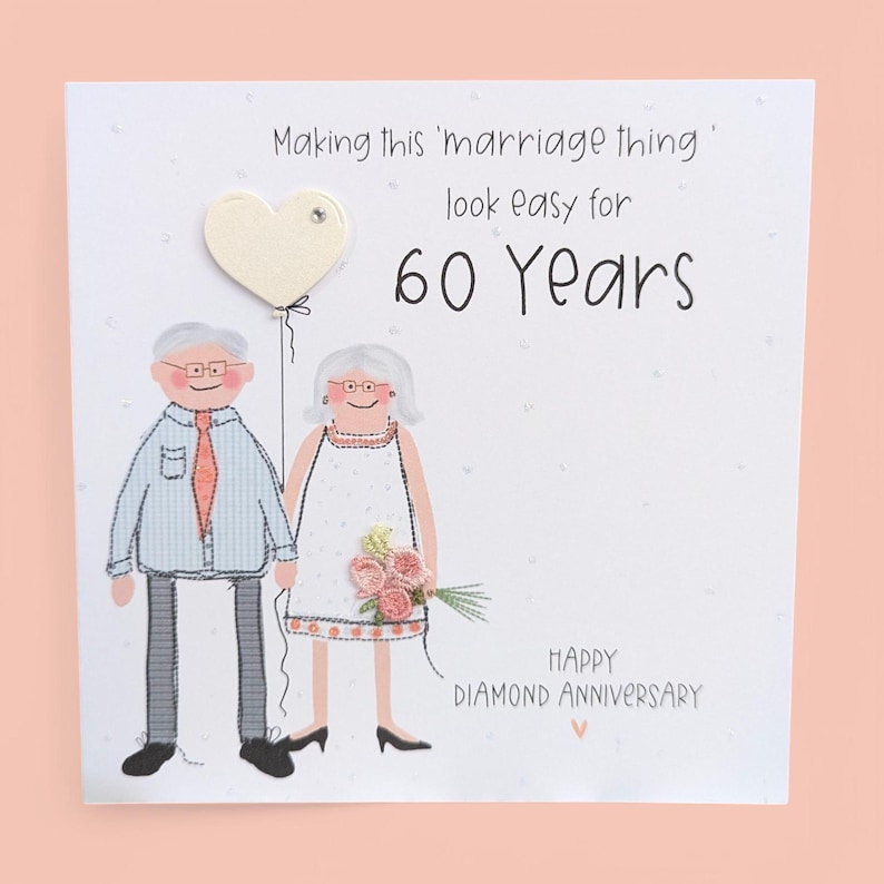 May include: A square greeting card featuring a cartoon illustration of an older couple. The text reads: Making this 'marriage thing' look easy for 60 Years. Below is the text: HAPPY DIAMOND ANNIVERSARY. The couple holds a heart-shaped balloon.