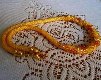 Crocheted necklace in rockery beads and SWAROVSKI crystal tops, shades of yellow