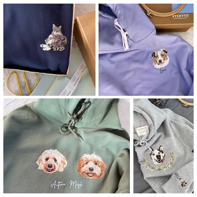 May include: Four different hoodies with embroidered pet portraits. The first hoodie is navy blue with a cat portrait. The second hoodie is light purple with a dog portrait. The third hoodie is green with two dog portraits. The fourth hoodie is grey with a dog portrait.