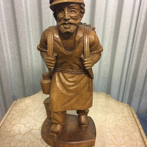 Artisan carving wood with chisels