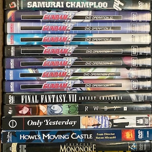 May include: A stack of DVD cases featuring anime and fantasy titles, including "Dragon Ball GT", "Gungrave", "Samurai Champloo", "Mobile Suit Gundam", "Final Fantasy VII: Advent Children", "Only Yesterday", "Howl's Moving Castle", "Princess Mononoke", "Watchmen", "Justice League: Gods and Monsters", and "Cowboy Bebop".
