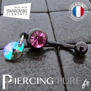 May include: Black belly button ring with a pink Swarovski crystal and a dangling iridescent crystal. The ring is made in France and features the text "Made with Swarovski Elements" and "Modeles Uniques".