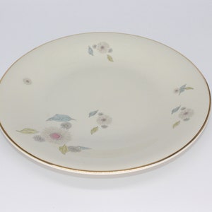 Large gold-rimmed plate with a floral pattern