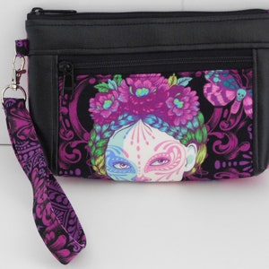 double zipper devon wristlet made with Tula Pink deLuna line.  Has faux leather accents and fully lined.