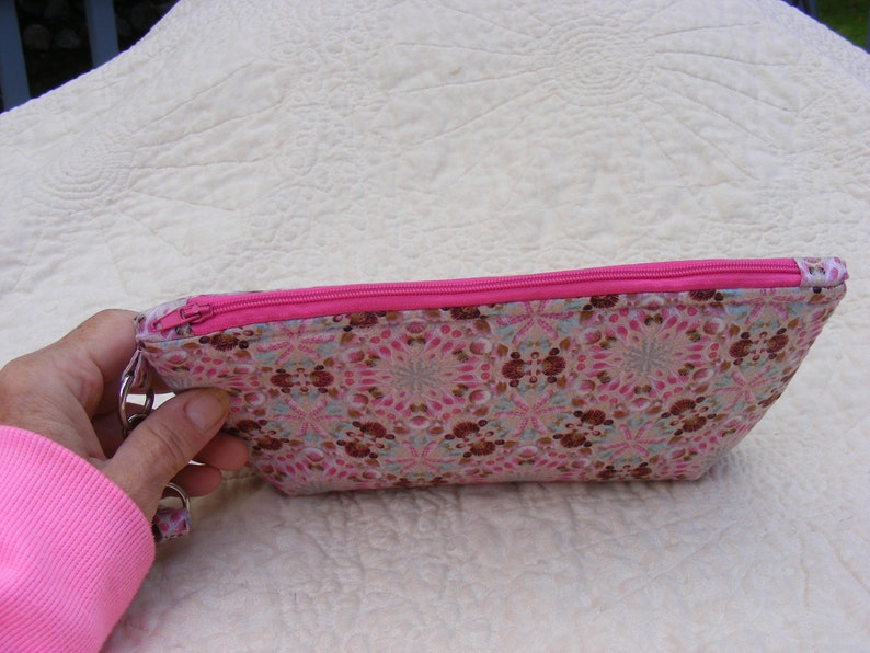 Pink and brown sea shell print wristlet