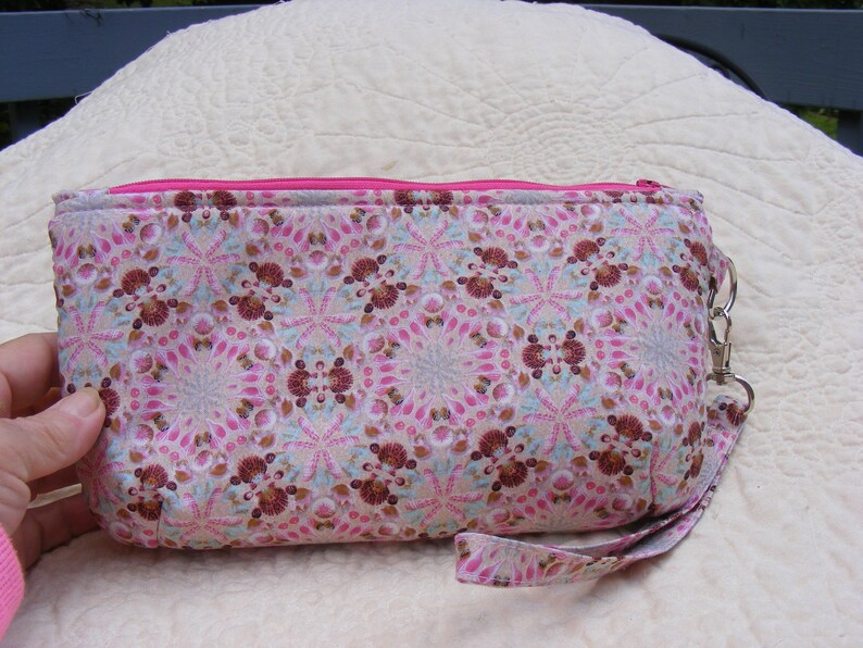Pink and brown sea shell print wristlet