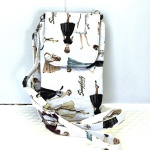 May include: A white crossbody phone purse with a long adjustable strap. The purse has a flap closure and is decorated with a vintage-inspired print of women in dresses. The print includes the text "Simplicity Vintage".