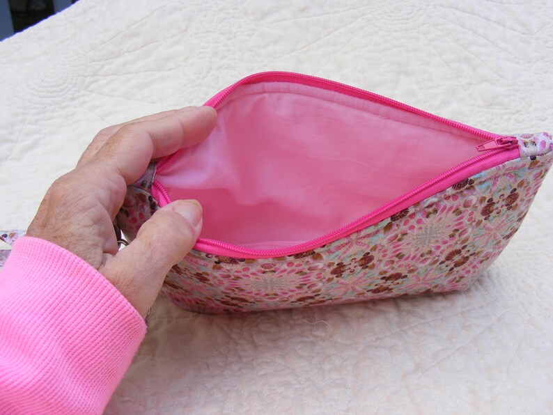 Pink and brown sea shell print wristlet