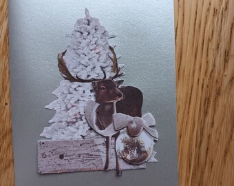 Christmas card with fir tree and reindeer silver background