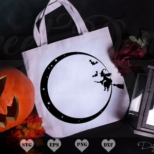 May include: A white tote bag with a black silhouette of a witch flying on a broomstick in front of a crescent moon. The moon is surrounded by stars. The bag is on a black surface with a pumpkin, fall leaves, and a black lantern.