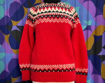May include: Red knitted sweater with a black, white and red geometric pattern around the neck and cuffs.