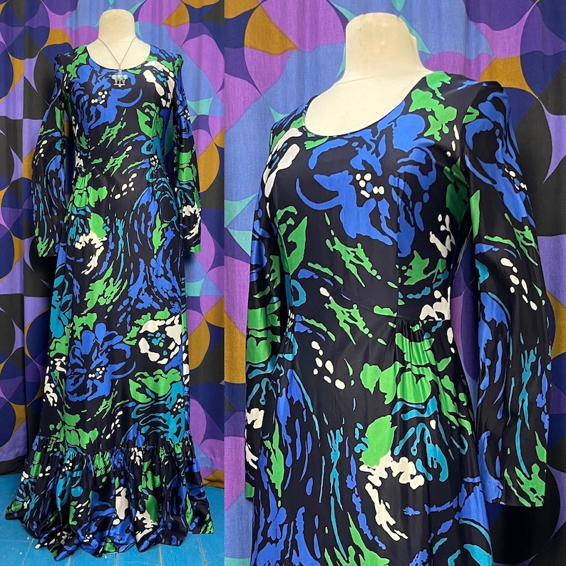 May include: A long-sleeved maxi dress with a blue, green, and white abstract floral print. The dress has a round neckline and long bell sleeves.