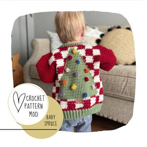 May include: A red and white checked crochet sweater with a green Christmas tree design on the back. The tree has colourful ornaments and a brown trunk. The sweater is labelled "Baby Spruce" and "Crochet Pattern Mod".