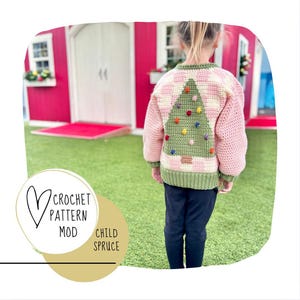 Könnte beinhalten: Ein rosa-grüner Häkelpullover mit einem grünen Weihnachtsbaum-Design auf der Rückseite. Der Baum hat bunte Ornamente und einen braunen Stamm. Der Pullover wird von einem Kind getragen.