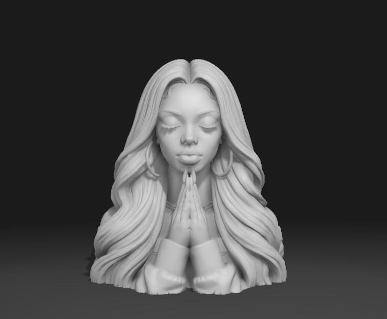 May include: A grayscale sculpture of a woman with long, flowing hair and closed eyes. Her hands are clasped together in a praying position. The sculpture has a serene expression and is set against a dark background.