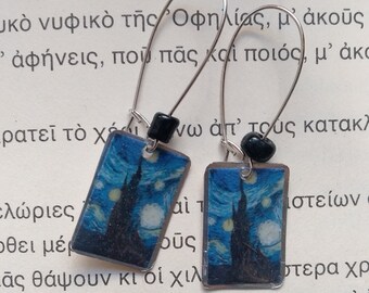 May include: A pair of silver earrings with black beads and rectangular charms featuring a painting of a starry night sky. The charms are made of metal and have a clear protective coating.