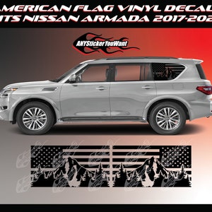 May include: A silver Nissan Armada SUV with American flag vinyl decals on the rear windows. The decals feature a mountain range and pine trees in black silhouette. The text "ANYsticker YouWant" is visible on the image.