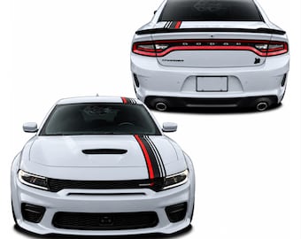 May include: A white Dodge Charger shown from the front and rear, featuring a black and red racing stripe decal running along the bonnet, roof, and boot. The vehicle includes a black rear spoiler, dual exhaust pipes, and the Dodge logo.