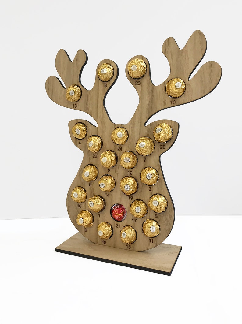 3D oak reusable reindeer advent calendar with circles to fit Ferrero Rocher and Lindor Truffles in  all with the countdown to Christmas etched in random order