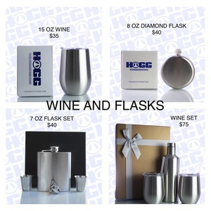 May include: Four gift boxes containing different stainless steel wine and flask sets. The boxes are brown and white with a white ribbon. The sets include a 15 ounce wine glass, a 7 ounce flask set, an 8 ounce diamond flask, and a wine set with a bottle and two glasses.