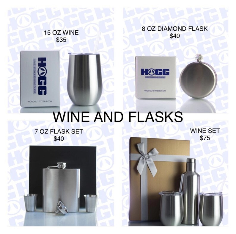 May include: Four gift boxes containing different stainless steel wine and flask sets. The boxes are brown and white with a white ribbon. The sets include a 15 ounce wine glass, a 7 ounce flask set, an 8 ounce diamond flask, and a wine set with a bottle and two glasses.