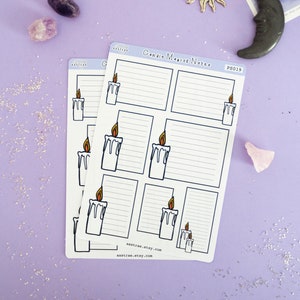 May include: Two sheets of candle magic notes with a white background and black lines. Each sheet has six sections with a candle illustration and space for writing. The text "Candle Magic Notes" and "PS019" are printed on the top of the sheet. The sheets are on a purple background with glitter.