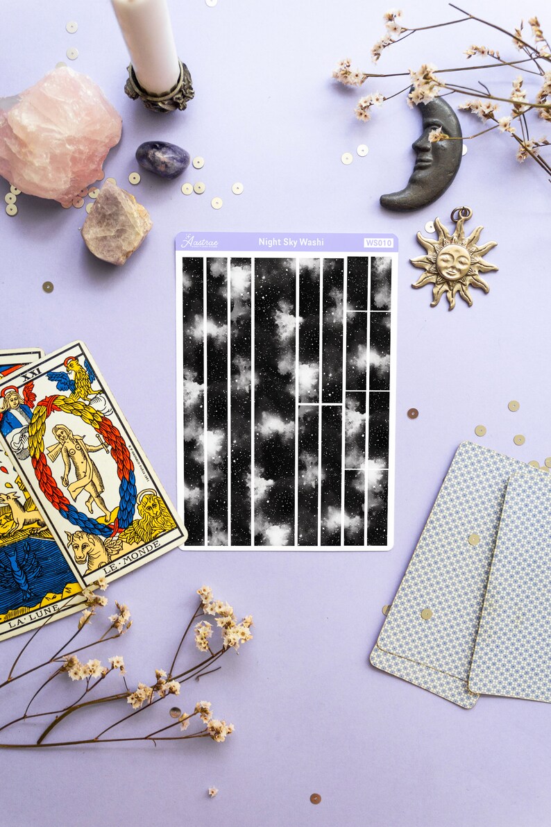 May include: A sheet of black and white washi tape with a night sky design featuring clouds and stars. The tape is labeled "Night Sky Washi" and "WS010".
