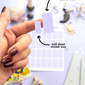 May include: Two light purple stickers, one small and one large, are held up against a grid background. The text indicates the sizes as "full sheet sticker size" and "half sheet sticker size". The background is a light purple color.