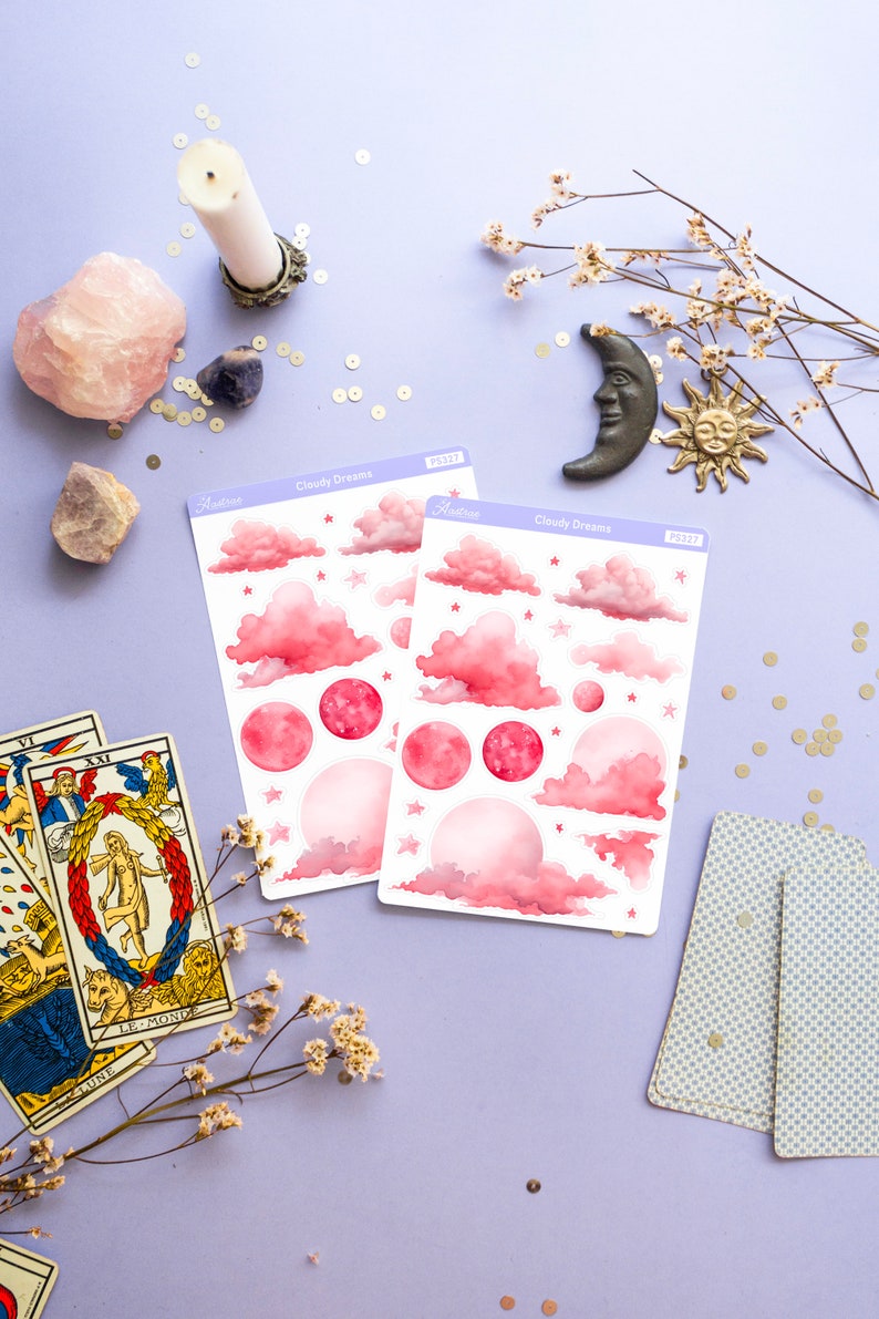May include: Two sheets of pink and white watercolor stickers with clouds, stars, and moons. The stickers are labeled "Cloudy Dreams" and have a product number.