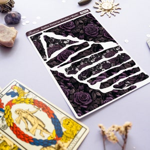 May include: A sheet of decorative washi tape with a gothic Victorian garden design. The tape features a dark background with purple roses and vines. The text "Gothic Victorian Garden - Washi" is printed on the tape.