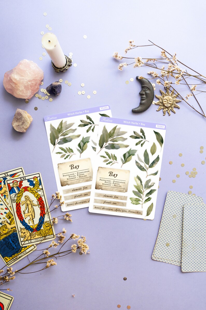 May include: Two sheets of stickers featuring illustrations of bay leaves with the text "Witch Herbs - Bay" and "Bay" with information about the herb's properties, including protection, purification, psychic power, strength, healing, element: fire, planet: sun, deities:  Apollo, Ceres, Pan,  Diana, Eros.
