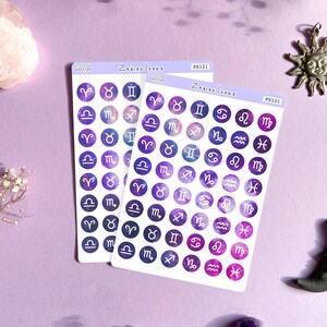 May include: Two sheets of stickers with purple and white zodiac signs on a galaxy background. The stickers are round and have a white border. The text "Zodiac Icons" and "PS121" is printed on the sheets.