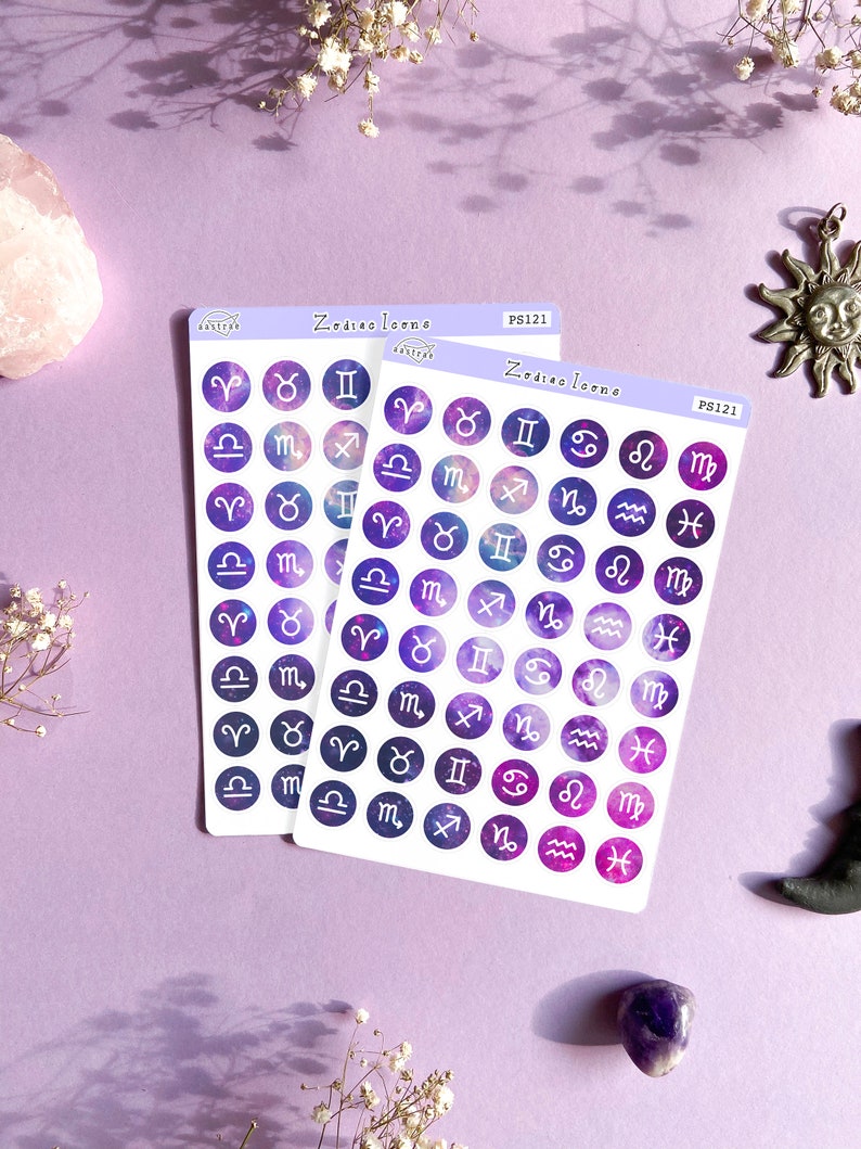 May include: Two sheets of stickers with purple and white zodiac signs on a galaxy background. The stickers are round and have a white border. The text "Zodiac Icons" and "PS121" is printed on the sheets.