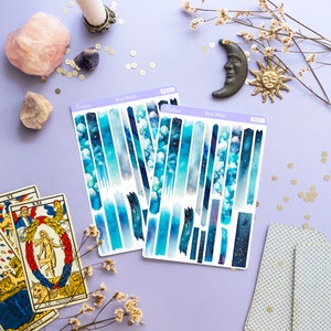 May include: Two sheets of blue and white washi tape with a galaxy design. The tape is labeled "Blue Wash" and has the product number PS2231.