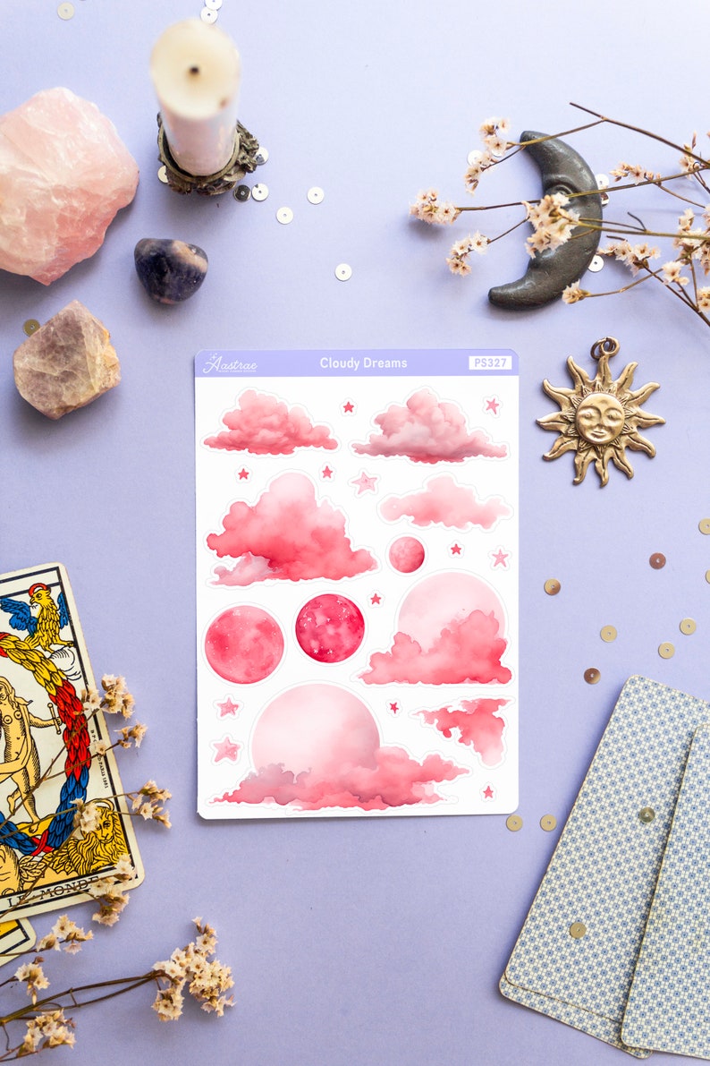 May include: A sheet of pink and white stickers with a watercolor design of clouds, stars, and moons. The sheet is labeled "Cloudy Dreams" and "PS327".