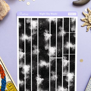 May include: A sheet of black and white washi tape with a night sky pattern. The tape is divided into 12 strips, each with a different section of the night sky. The washi tape is labeled "Night Sky Washi" and "WS010".