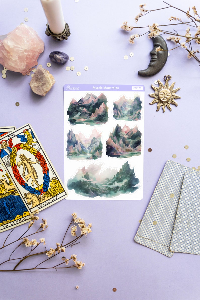 May include: A sheet of stickers featuring five watercolor illustrations of misty mountains. The stickers are on a white background and have a glossy finish. The sheet is labeled "Mystic Mountains" and "PS371".