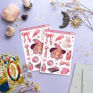 May include: Two sheets of pink and white stickers featuring a pink-haired witch with a cat, a moon, stars, a book, a bottle, and a pink bow. The sticker sheets are labeled "Pink Coquette Witch + Deco" and "PS553".
