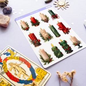 May include: A sheet of stickers featuring illustrations of Yule candles. The candles are decorated with red, green, and white accents. The stickers are labeled "Yule Candles" and "PS318".