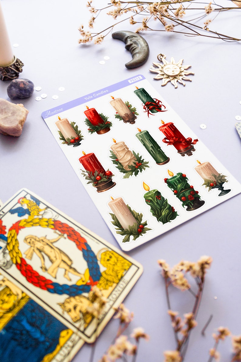 May include: A sheet of stickers featuring illustrations of Yule candles. The candles are decorated with red, green, and white accents. The stickers are labeled "Yule Candles" and "PS318".